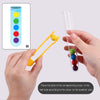 Hands placing colored balls into a test tube according to a color chart for a Montessori game