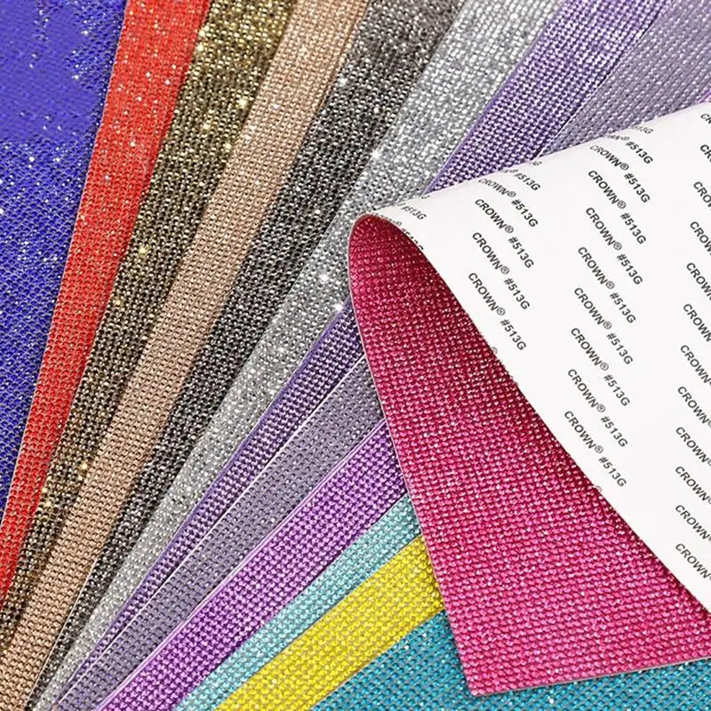 A variety of sparkling rhinestone adhesive tape in various colors and finishes laid out for DIY crafts.