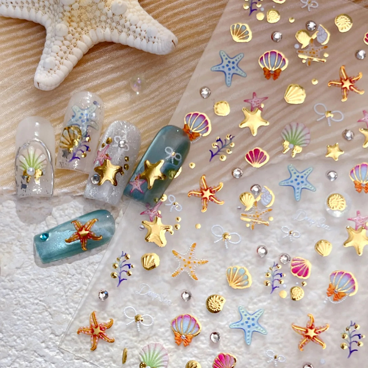 Clear stickers featuring gold starfish and seashell designs for nail art