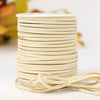 A stack of beige velvet faux suede braided ribbon rolls for crafting and gift wrapping.