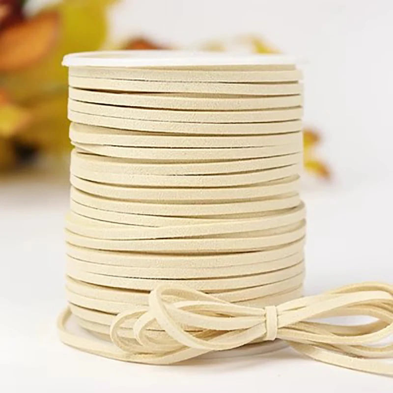 A stack of beige velvet faux suede braided ribbon rolls for crafting and gift wrapping.