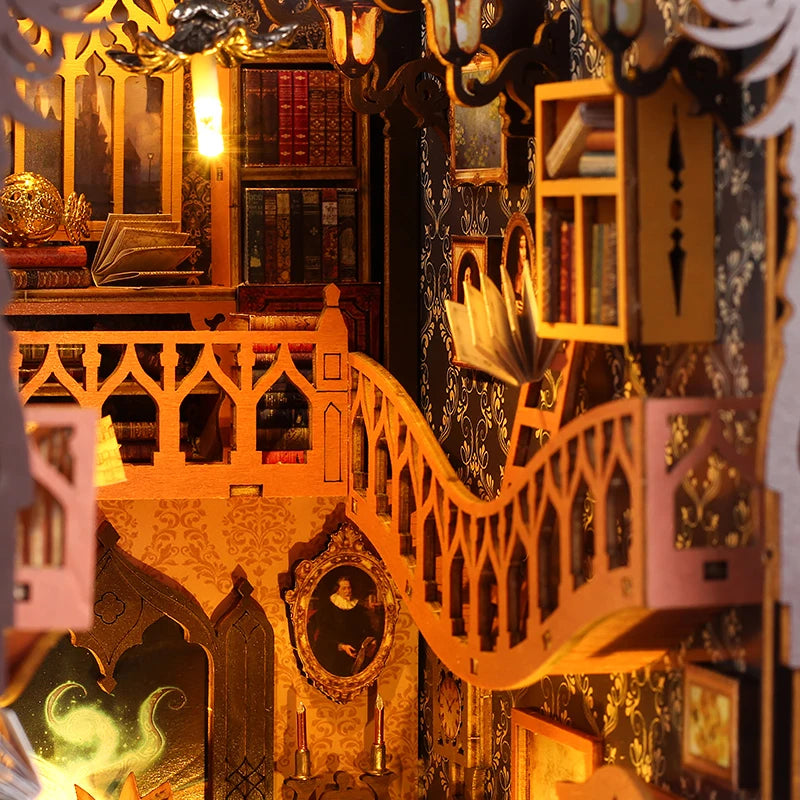 A detailed diorama of a DIY book nook kit featuring miniature furniture, bookshelves, and architectural elements.