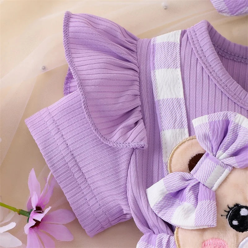A purple plaid romper dress for a baby girl featuring white stripes and ruffle details.
