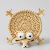Handmade crochet lizard coaster featuring a funny animal design in a beige color.