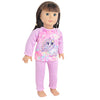 A doll wearing a pink unicorn pajama set with purple and yellow accents.