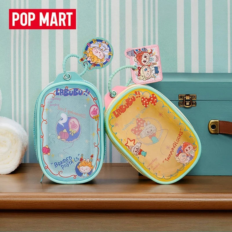 A colorful LABUBU doll bag pendant keychain featuring a monster character and accessories, displayed on a wooden surface.