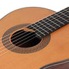 Close-up view of a classical guitar showing the soundhole and fretboard with strings.