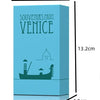 A light blue box labeled Souvenirs from Venice featuring a silhouette of a boat and a dome.