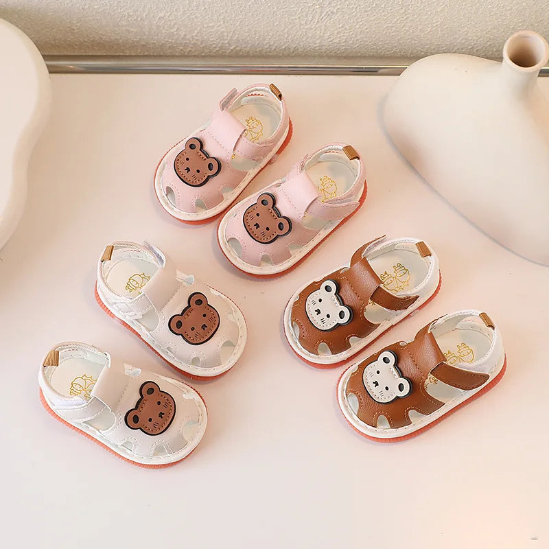 A collection of cute bear soft sole sandals for infants and toddlers in pink and brown tones.
