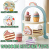 A wooden kitchen toy set featuring a coffee maker, tea accessories, and various food items displayed in an arched stand.