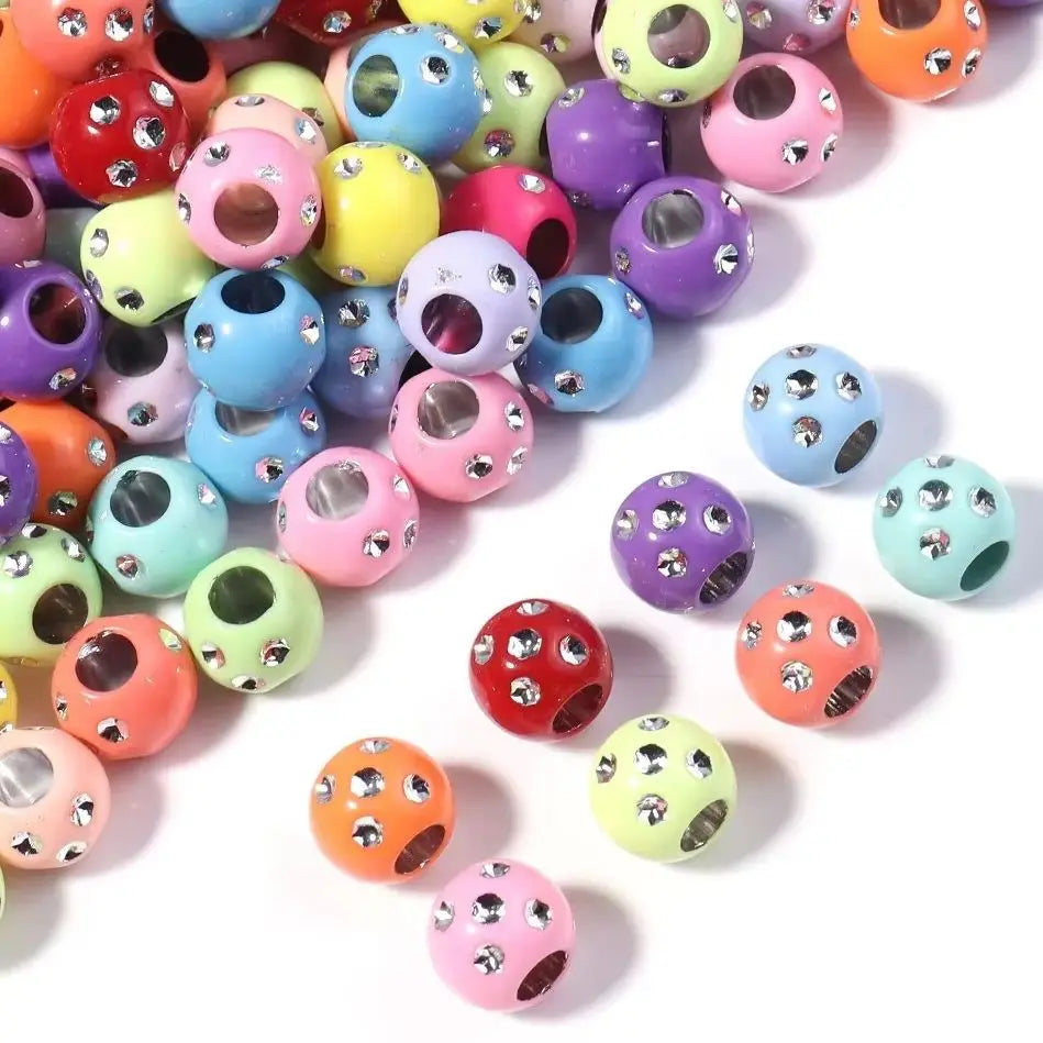 A collection of colorful rhinestone acrylic spacer beads in various shapes and sizes for jewelry making