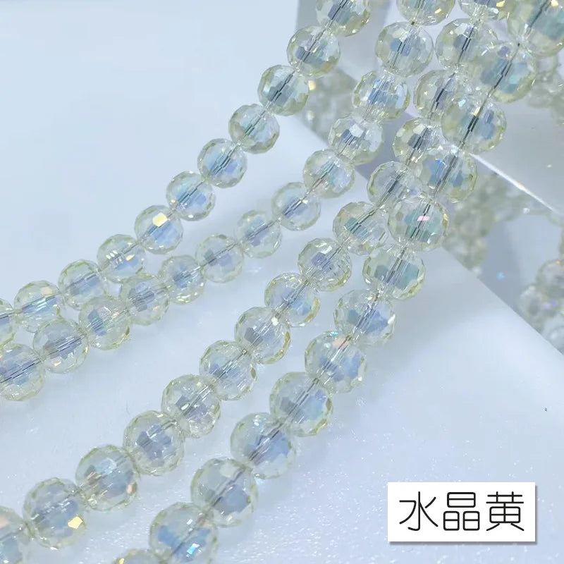 A close-up of clear crystal beads with an AB coating strung together on a thin wire.