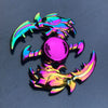 A shiny rainbow metal fidget spinner featuring a stylized dragon head and a round center piece.