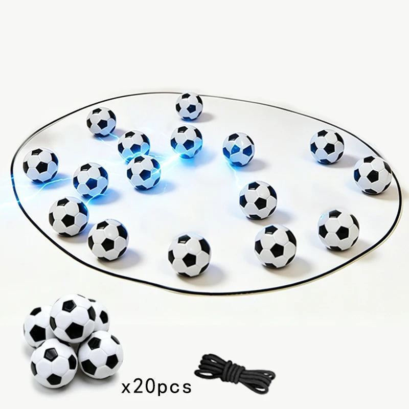 A magnetic soccer strategy board game featuring black and white soccer balls arranged on a clear oval surface.