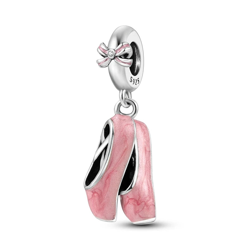 A silver heart charm bead with a pink zircon and a bow detail.