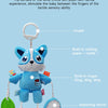 A blue plush toy with ears, feet, and a rattle attached to a hanging loop.
