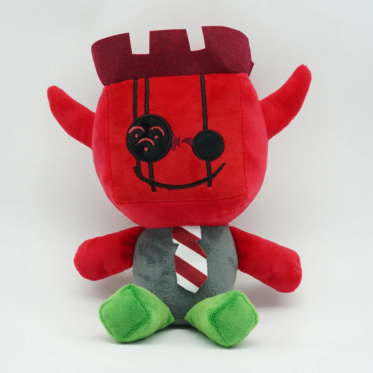 A plush toy resembling a rabbit with red and gray features, including a crown and a striped shirt.