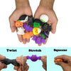 A hand holds various Halloween squishy stress relief toys including ghost, cat, and pumpkin shapes in twist, stretch, and squ