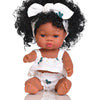 A dark-skinned baby doll with curly hair wearing a white outfit and a white bow