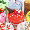 A collection of colorful slime containers and a red slime jar with a witch hat decoration.
