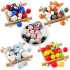 Assortment of colorful cartoon animal silicone beads for DIY jewelry making displayed on wooden trays.