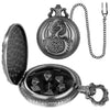 A silver steampunk dragon pocket watch dice case with a lid and a chain, alongside seven mini dice.