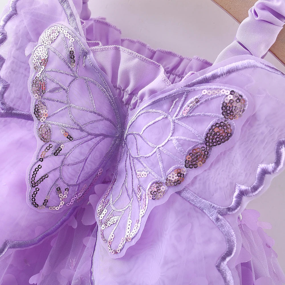 A purple princess-style butterfly suspender dress for a baby girl with sheer fabric and sparkly embellishments.
