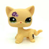 A yellow Littlest Pet Shop style standing dog figure with purple markings.