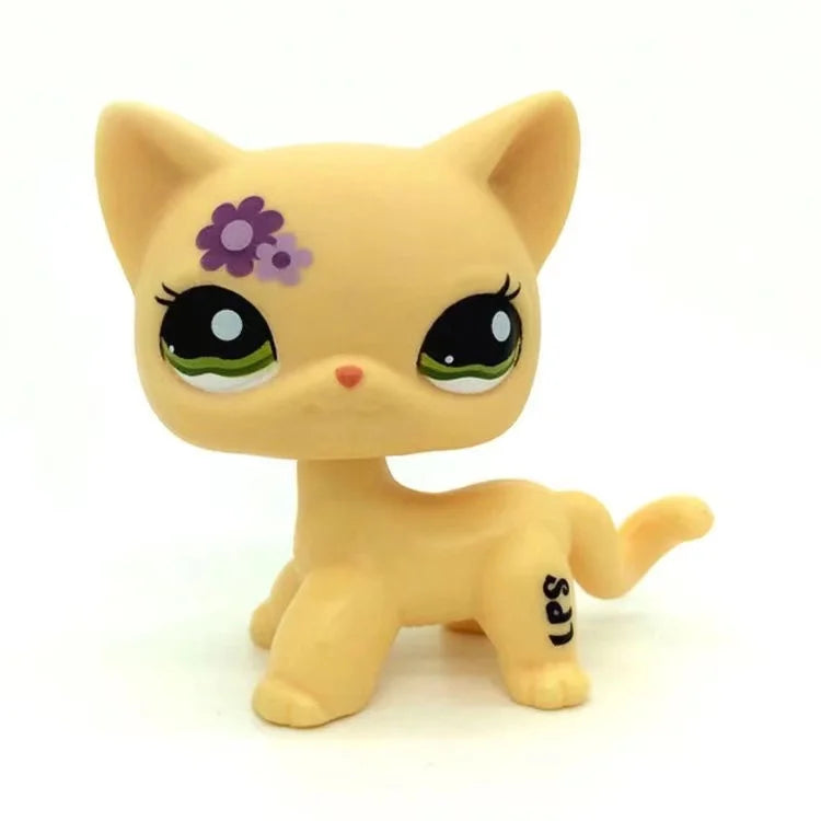 A yellow Littlest Pet Shop style standing dog figure with purple markings.