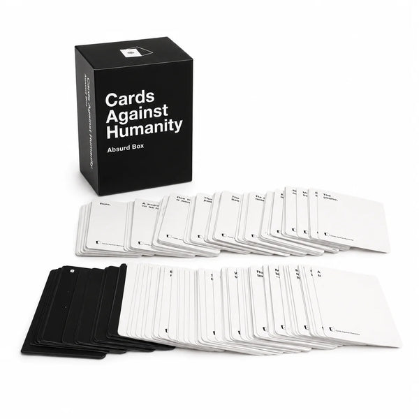 A black box of Cards Against Humanity party cards next to several stacks of white cards.