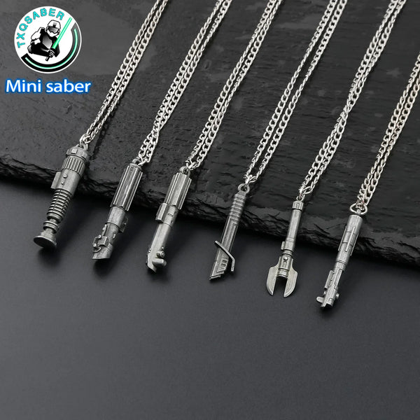A set of five silver metal mini saber keychain necklaces displayed against a dark background.