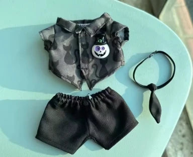 A set of Halloween pumpkin costume accessories for dolls, including a camouflage shirt and black shorts.