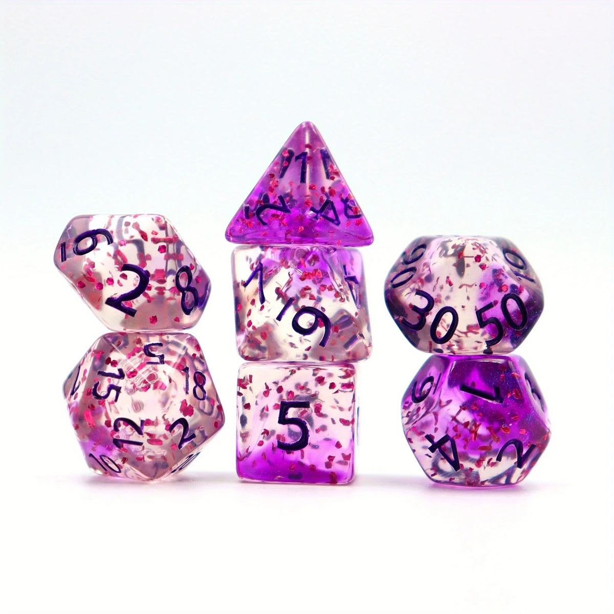 A set of crystal-style polyhedral dice in various shapes and colors, including a pyramid and a dodecahedron.