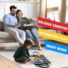 A family is engaged in quiet play with a Montessori busy board for toddlers on the floor.