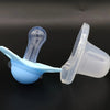 A set of two silicone pacifiers with protective covers, one blue and one clear, displayed against a dark background.