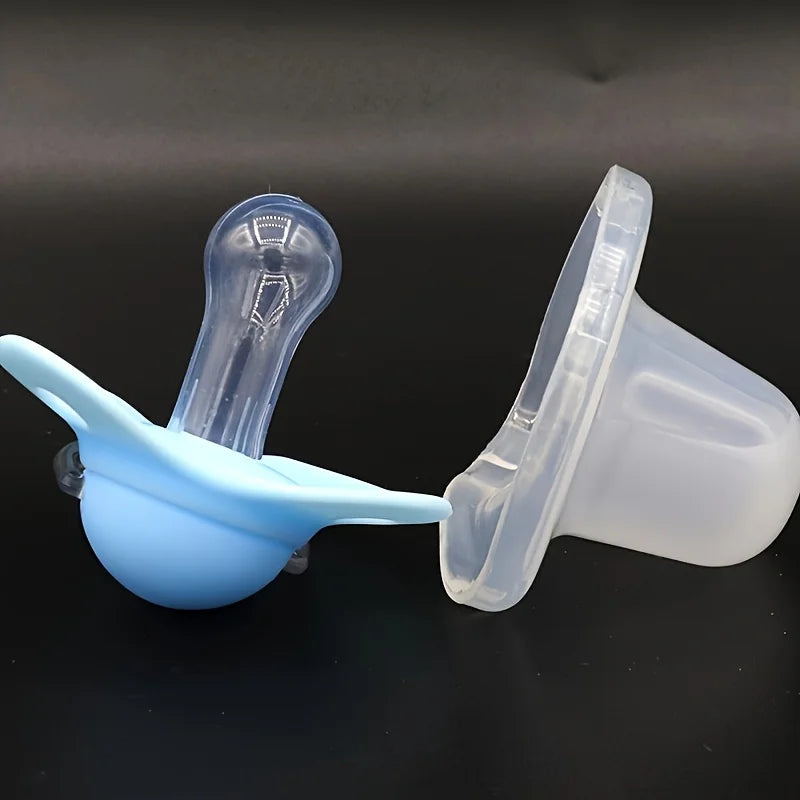 A set of two silicone pacifiers with protective covers, one blue and one clear, displayed against a dark background.