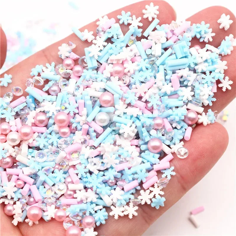 A hand holds a pile of polymer clay slices assortment in pink, blue, and white colors for DIY crafts.