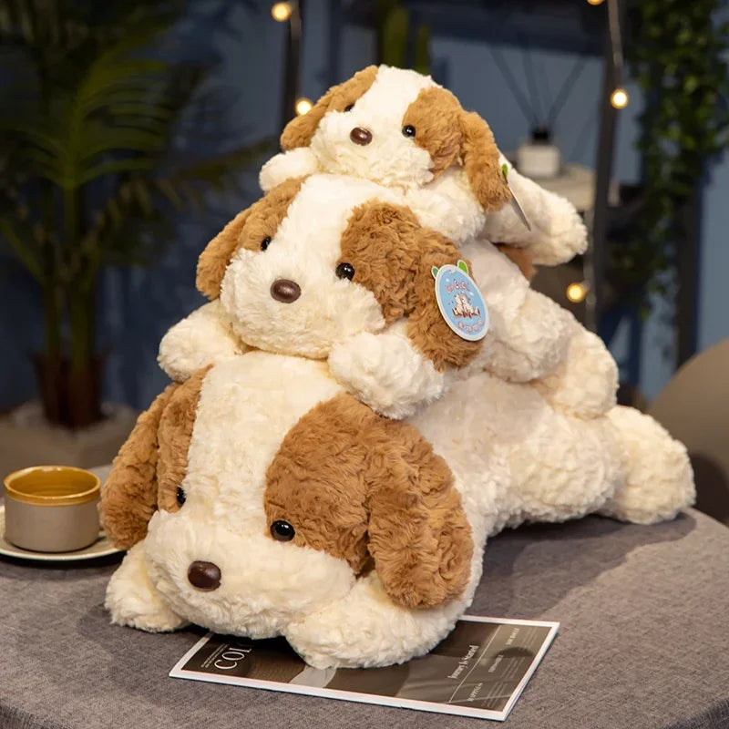 A fluffy brown and white dog plush toy lying down on a gray surface.