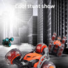 Orange and black stunt car with large wheels is shown in a studio setting.