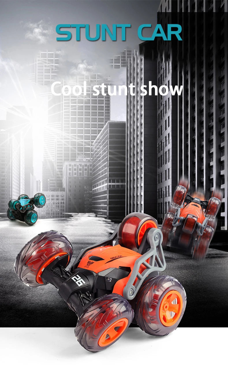 Orange and black stunt car with large wheels is shown in a studio setting.