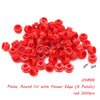 A pile of red round plates with a flower edge for building blocks