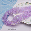 Purple faceted crystal rondelle beads for jewelry making displayed on a white surface.