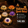 A collection of Halloween-themed squishy fidget toys including pumpkin and ghost shaped items displayed on a dark wooden surf
