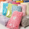 A collection of multicolored raffia paper shreds in various shades including pink, green, blue, and white.