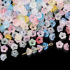 A pile of colorful gradient bellflower acrylic beads in various shades of pink, blue, yellow, and green.