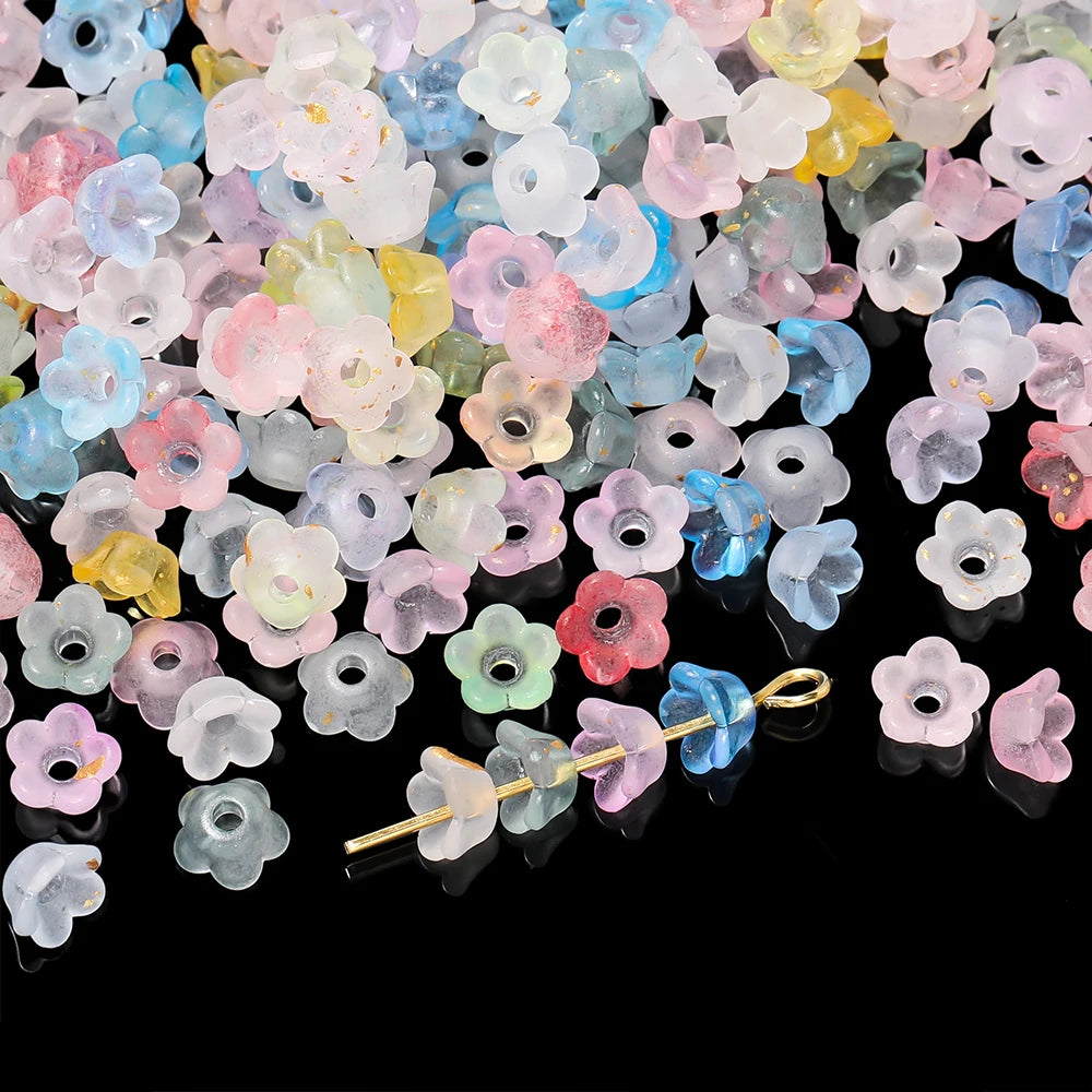 A pile of colorful gradient bellflower acrylic beads in various shades of pink, blue, yellow, and green.