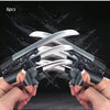 Six pieces of silver and black retractable mechanical wolf claw props being held by hands against a dark background.