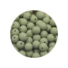 A circular arrangement of assorted silicone beads in various shades of green.
