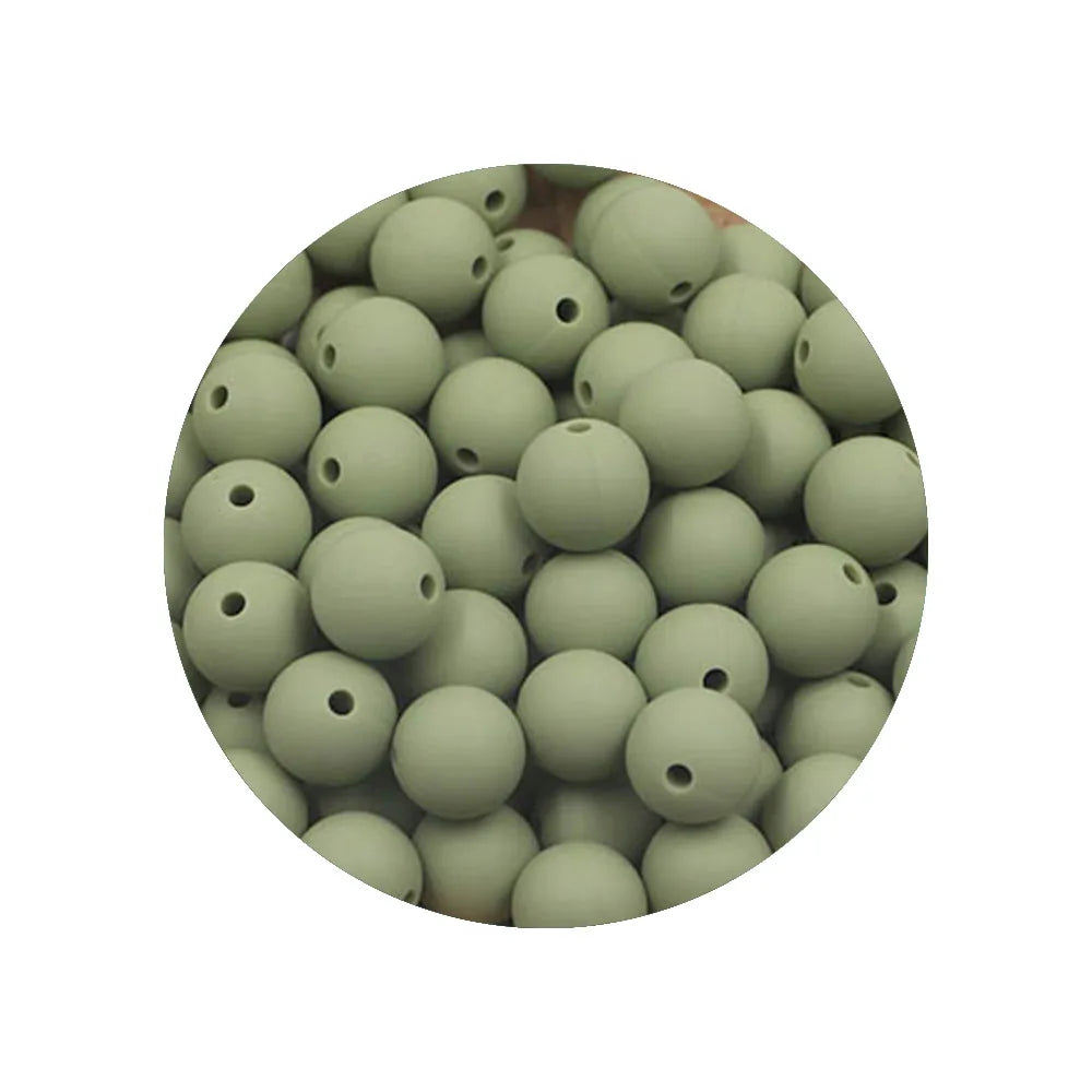 A circular arrangement of assorted silicone beads in various shades of green.
