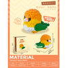 A set of colorful parrot micro building blocks featuring a yellow bird and green foliage, packaged in a box.